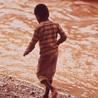 Boy Walks Along Creek Polluted By Steel Mill Effluent, July 1972