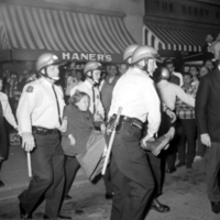 A University of Michigan student is arrested by police at the October 15th, 1965 Selective Service Office sit-in in Ann Arbor.