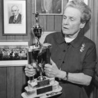 Margaret Bell, UM Dept. Phys. Ed. for Women, posed with Margaret Bell Trophy, presented to the Michigan Girls Swimming League Team Champion
